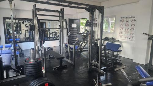 a room with a gym with several tread machines at Tablas Seaview Homestay in Ferrol