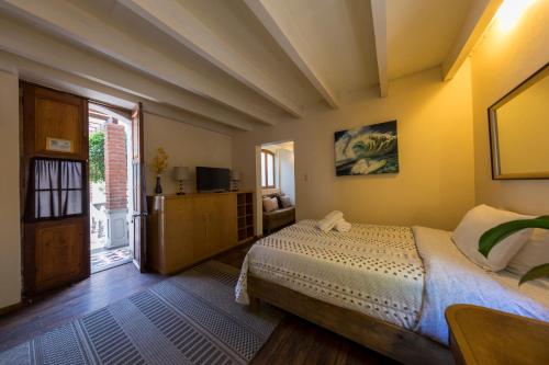 a bedroom with a bed and a large window at Meztli: Casa Boutique & Spa in Mexico City