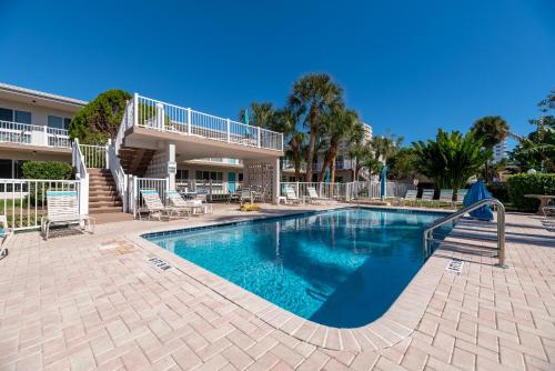 a swimming pool in front of a building with a resort at The Floranada Condo at Pompano Beach 9 in Pompano Beach