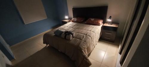 a bedroom with a bed with a backpack on it at FORMOSA RELAX in Formosa