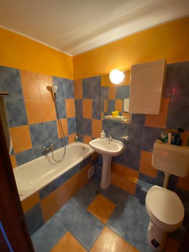 a bathroom with a sink and a toilet and a bath tub at Elixir studio in Bucharest