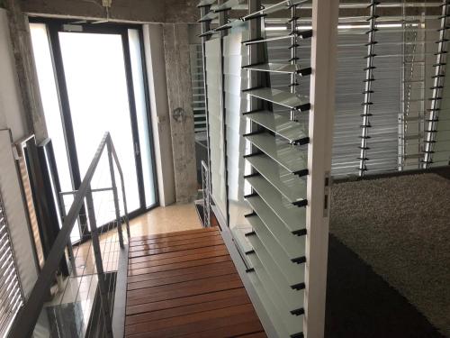 a room with a wall of empty wine racks at WAREHOUSE RARE!! MASSIVE LUXURY ARCHITECTURAL MASTERPIECE w HUGE PRIVATE ROOFTOP GARDEN WITH PANARAMIC CITY VIEWS in Sydney