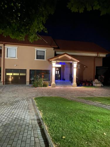 a house with a lit up garage at night at Villa Magnifica in Strumica