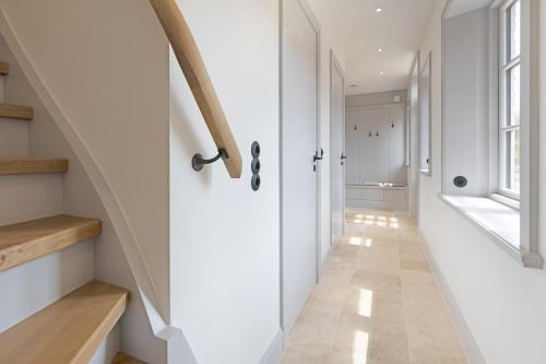 a hallway with a white door and a staircase at Westport in List