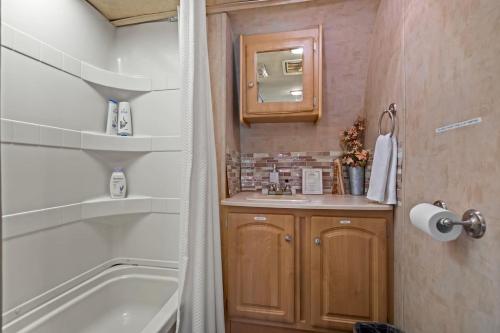 a bathroom with a tub and a sink at JT Village Campground - Star Stream in Joshua Tree