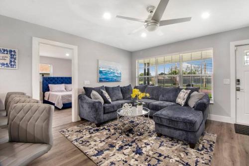 a living room with a couch and a table at Modern getaway near the beach with room for a boat in West Palm Beach