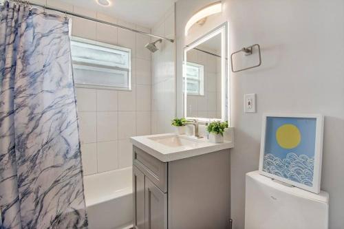 a bathroom with a sink and a shower curtain at Modern getaway near the beach with room for a boat in West Palm Beach