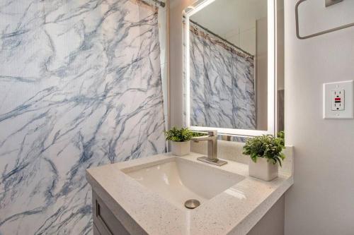 a bathroom with a sink and a mirror at Modern getaway near the beach with room for a boat in West Palm Beach
