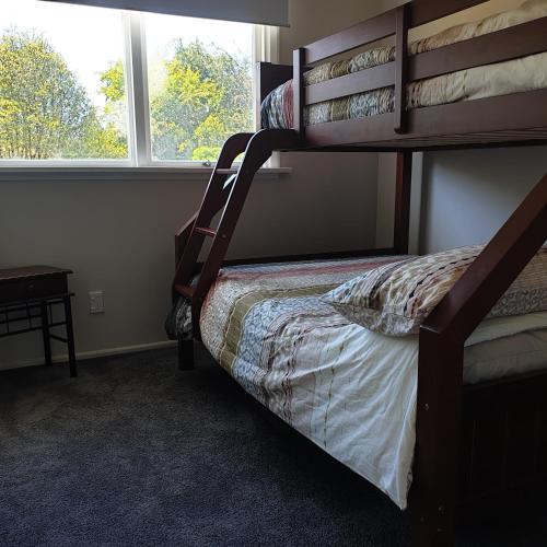 a bedroom with a bunk bed and a window at Lavender Row Farm in Outram