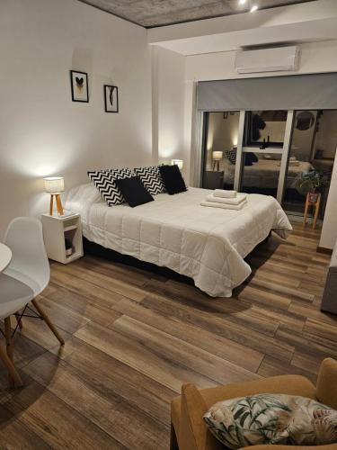 a bedroom with a large bed and a wooden floor at Belgrano BLUE Apartment in Buenos Aires