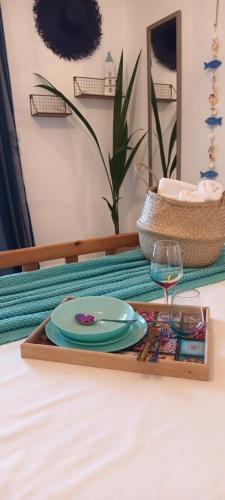 a tray with a plate and a glass on a table at Mana mia Seaside Apartments in Leptokaria