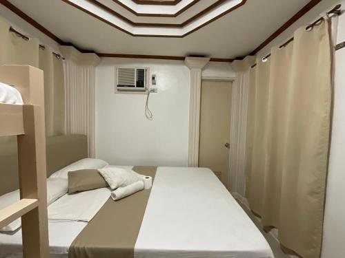 a bedroom with two beds and a ceiling at LISA'S GUESTHOUSE in Basdiot