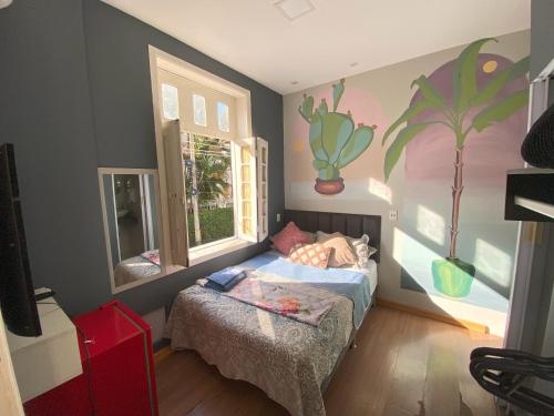 a small bedroom with a bed and a window at Aurora Hostel Rio in Rio de Janeiro