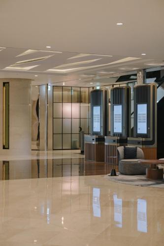 a lobby of a building with a waiting room at Lotte Hotel World in Seoul