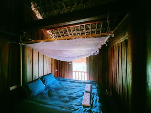 a bedroom with a bunk bed with a mosquito net at Lagom Su Phi Retreat in Hoàng Su Phì