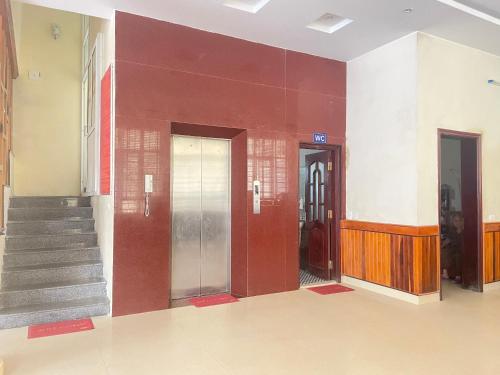 a hallway with doors and stairs in a building at Trường Sa Hotel Cửa Lò Beach in Cửa Lò