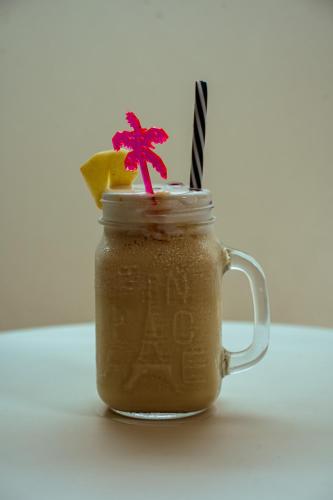 a mason jar filled with a drink on a table at Hotel Black Diamond - Transit Point Inside Hotel in Kathmandu