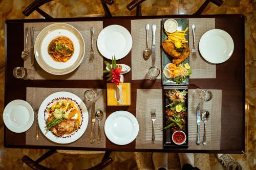 a table with plates of food on top of it at Hotel Black Diamond - Transit Point Inside Hotel in Kathmandu