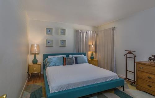 a bedroom with a blue bed and two night stands at 5208 Pine Street in Mariposa