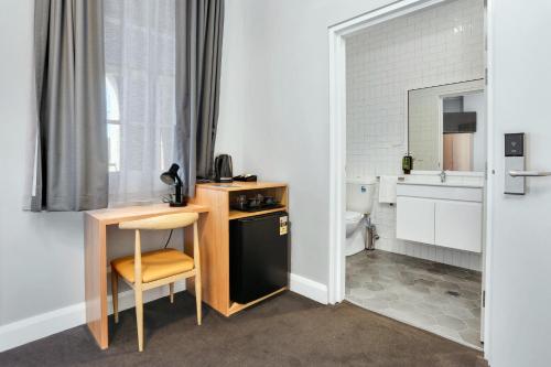 a small kitchen with a desk and a toilet at Penshurst Hotel in Sydney