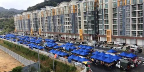 an aerial view of a large apartment complex with blue umbrellas at Sweet Homestay 3RM @ Penthouse Apartment in Brinchang in Brinchang