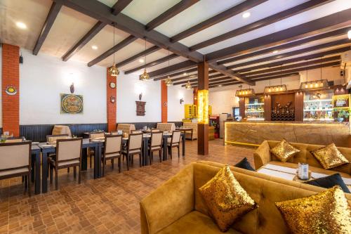 a restaurant with couches and tables and a bar at Hukum Darbar Restaurant & Hotel in Kathmandu