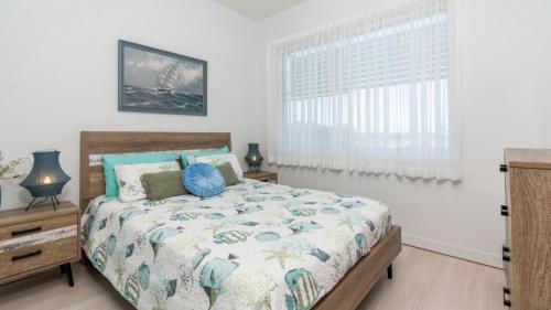 a bedroom with a bed and a window at Town Centre & Beach At Your Door Step in Woorim