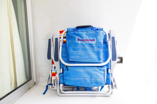 a blue towel rack in front of a window at Fully Renovated 2BR and 2BA Near Waikiki Beach with Parking in Honolulu