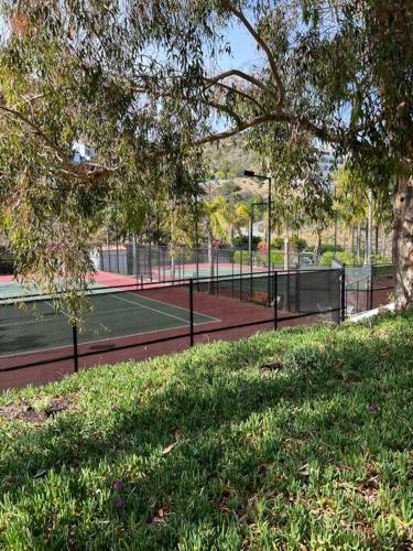a tennis court in a park with a tree at Hamilton Cove Panoramic Ocean View Condo #2/32 in Avalon