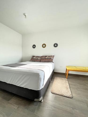 a bedroom with a large bed and a wooden table at Apartamento 30min del Mar in Cartagena de Indias