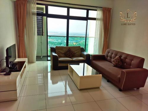 a living room with two couches and a television at Luxe Suites at Skyloft in Johor Bahru