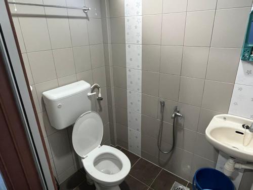 een badkamer met een toilet en een wastafel bij Ayem Homestay UTHM in Parit Raja