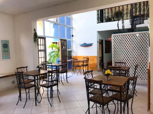 a restaurant with tables and chairs in a room at Pousada Beluga in Búzios