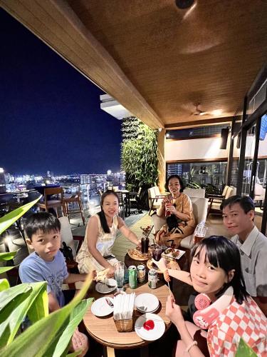 a group of people sitting around a table at a restaurant at Diamond Sea Hotel in Da Nang