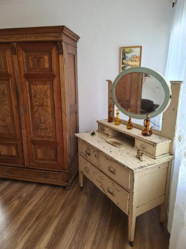 a dressing table with a mirror on top of it at La cachette bushland hideaway in Ironbank