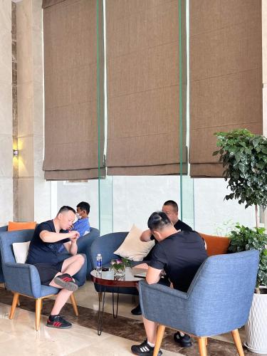 a group of people sitting around a table in a room at Diamond Sea Hotel in Da Nang