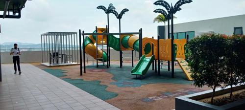 a playground with a slide in a building at Melangok Homestay in Kajang