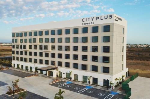 a large white building with a sign on it at City Express Plus by Marriott Mazatlan in Mazatlán