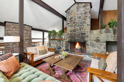 a living room with a large stone fireplace at Mountaineer Inn in West Dover