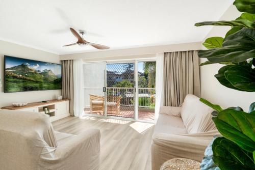 a living room with a couch and a ceiling fan at Markham Court in Gold Coast