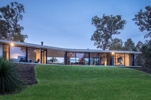 a house with large windows and a green yard at Boomerang House I Private Properties in Quindalup