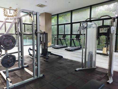 a gym with several tread machines in front of a window at Luxe Suites at Skyloft in Johor Bahru