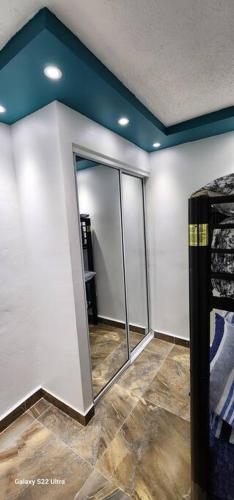 a room with a mirror on the wall and a room with at RH los angeles (#2) 2do floor front of airport in Sabana Abajo