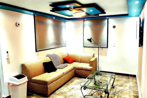 a living room with a couch and a glass table at RH los angeles (#2) 2do floor front of airport in Sabana Abajo