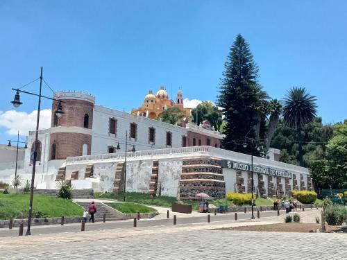 a large building in front of a building at Alojamiento HM in Cholula