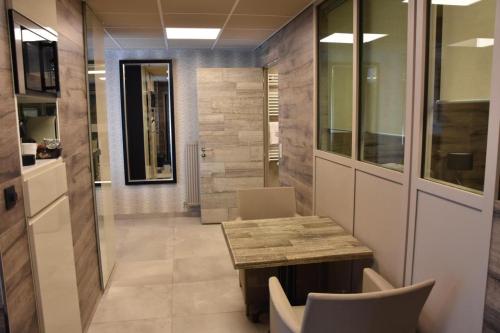 a hallway with a table and chairs in a room at Flat 40 by Malmedreams in Malmedy