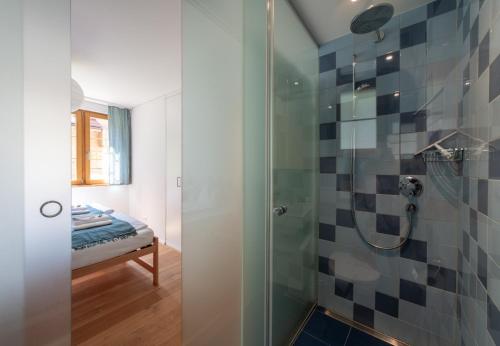 a bathroom with a shower with a glass door at Panoramapark Soleil E Apt 3 in Wengen