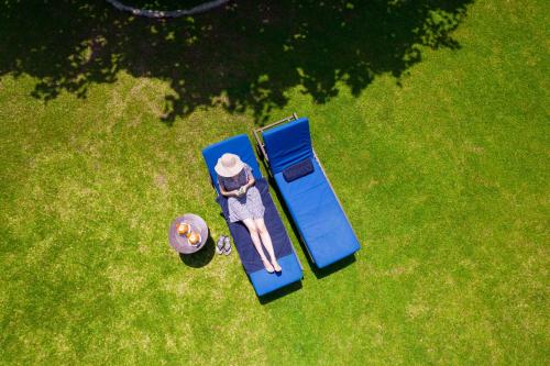 an overhead view of a woman sitting on a blue bench at The Palms in Bentota