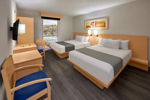 a hotel room with two beds and a television at City Express by Marriott Nogales in Nogales