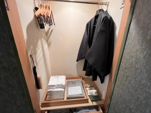 a walk in closet with a door open with a shelf at Jozankei Daiichi Hotel Suizantei in Jozankei
